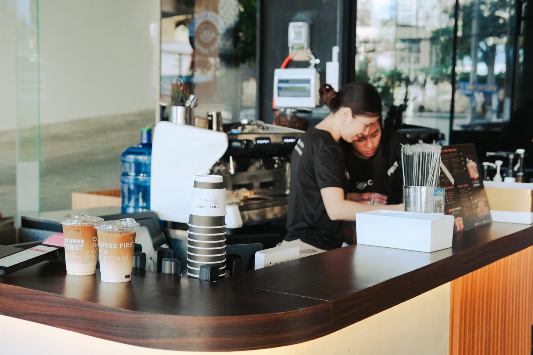 Two Coffee First team members working together at the Meridian branch